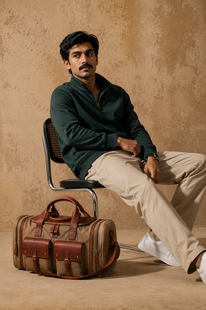 Lifestyle image of the Ladakh expandable canvas and leather duffle bag placed beside a seated model. made from durable canvas and reclaimed leather, this premium weekender bag features expandable compartments and vintage-inspired details, it's ideal for weekend getaways, airport travel and overnight journeys by one of India's premium duffle bag brands.