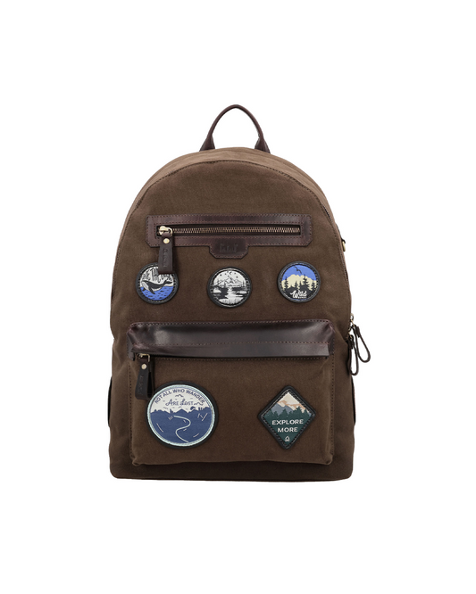 Brown canvas and reclaimed leather backpack featuring travel-inspired embroidered leather patches, dual zip pockets for an iPad, passport, earphones, and everyday essentials.