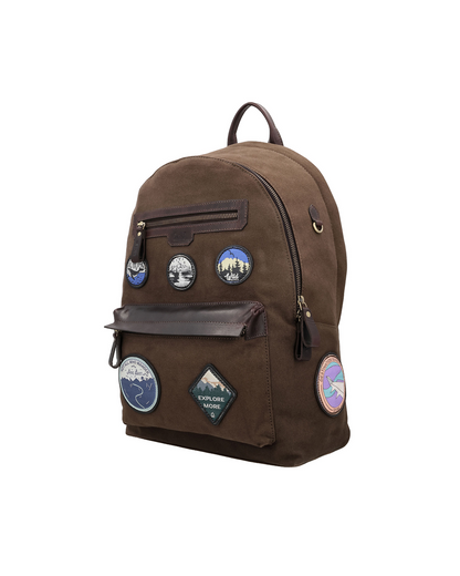 Brown canvas and reclaimed leather backpack with travel-inspired embroidered leather patches, two zip pockets for a passport, iPad, earphones, and small accessories.