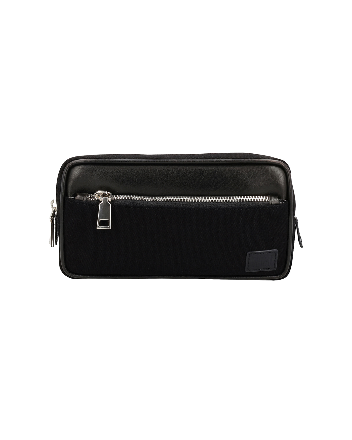 Studio Ek Inch Urban Traveller crossbody bag in black canvas and reclaimed leather with multiple zip compartments and an adjustable shoulder strap. Designed as a minimalist travel bag and canvas sling bag for men, it offers organized storage for everyday essentials and reflects the craftsmanship of one of the best backpack brands in India.