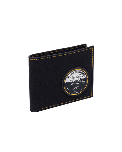 Black canvas and leather billfold wallet for men featuring a travel-inspired embroidered patch, designed as a slim everyday wallet with handcrafted details. This premium men's wallet from a premium leather bag brand of India is perfect for travel enthusiasts and makes a thoughtful birthday gift, anniversary gift, or festive gift for him.