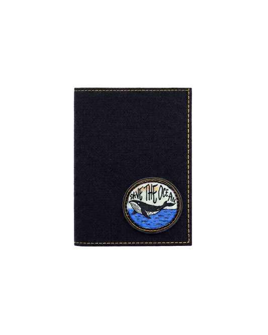 Black canvas and leather passport holder for travelers featuring a marine-inspired embroidered patch, designed to keep passports and travel documents organized. This luxury passport holder and premium leather passport case from a premium leather bag brand of India is ideal for frequent travelers and makes a thoughtful birthday gift, anniversary gift, or festive gift for him.