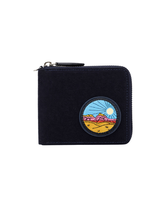 Black canvas and leather zip-around wallet for men featuring a colorful travel-inspired embroidered patch and secure zipper closure. This premium zip wallet from a premium leather bag brand of India offers compact storage for cash and cards, making it an ideal birthday gift, anniversary gift, or festive gift for him.