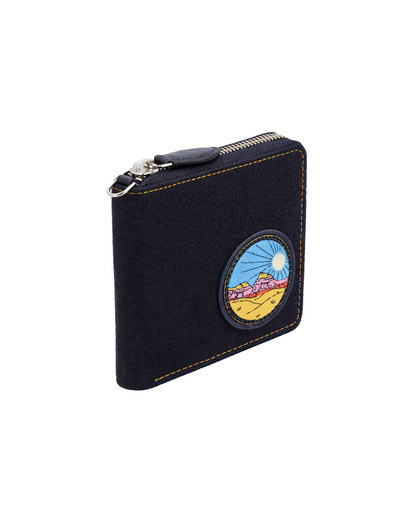 Black canvas and leather zip-around wallet for men featuring a colorful travel-inspired embroidered patch and secure zipper closure, crafted for carrying cash and cards. This premium zip wallet from a premium leather bag brand of India combines everyday functionality with handcrafted design and makes a thoughtful birthday gift, anniversary gift, or festive gift for him.