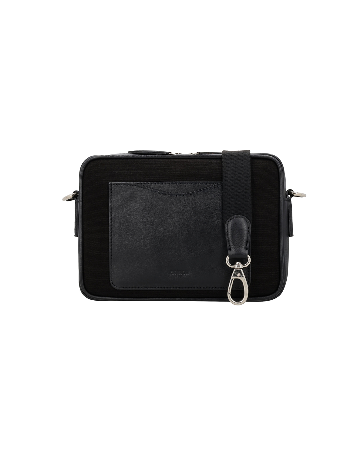 Back view of the Studio Ek Inch Metropolitan sling bag in black waterproof canvas and reclaimed leather, featuring a rear slip pocket and detachable shoulder strap. A premium crossbody bag designed for travel and everyday carry.