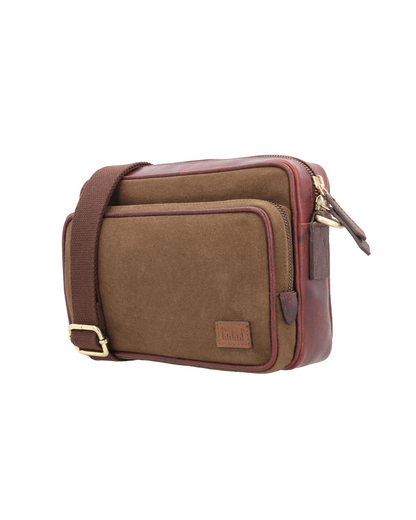 studio Ek Inch Metropolitan Sling crossbody bag crafted from waterproof canvas and reclaimed leather with multiple compartments for carrying a phone, wallet and everyday essentials. A premium sling bag designed for modern travel and daily movement.