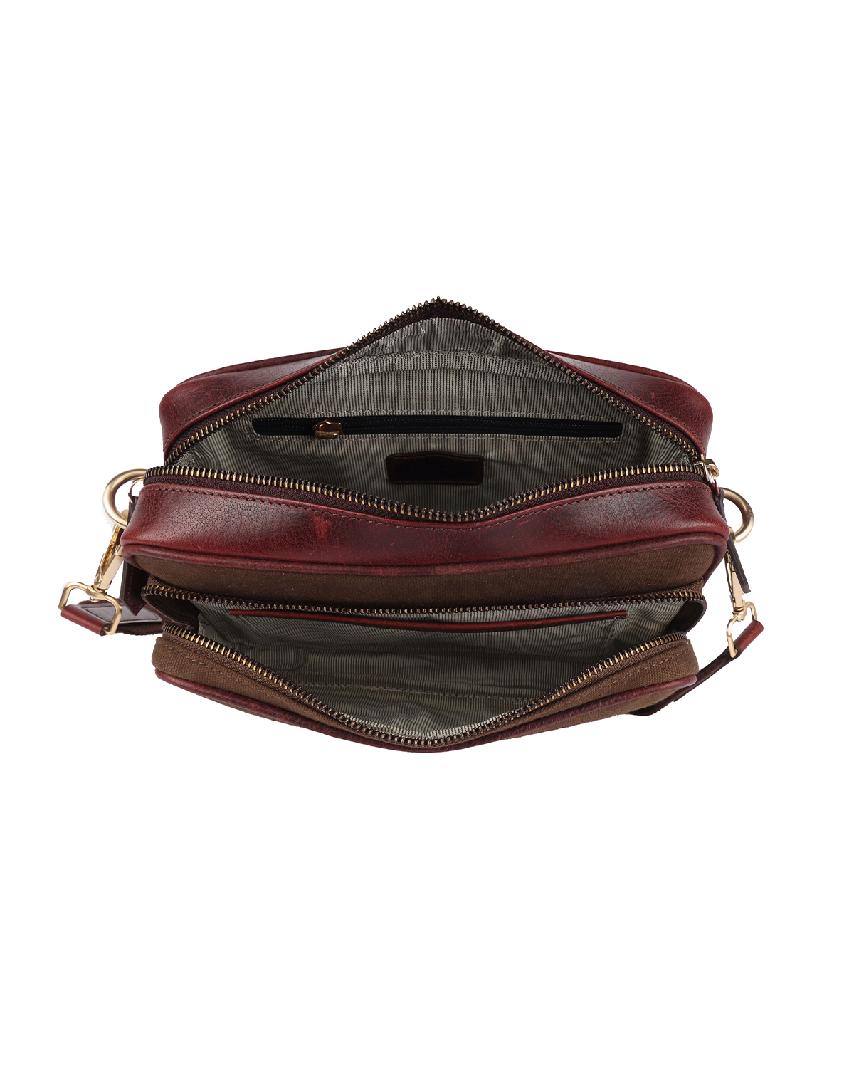 Top view of the Studio Ek Inch Metropolitan Sling bag showing spacious compartments for a smartphone, wallet, notebook and daily essentials. Crafted from waterproof canvas and reclaimed leather for modern travel.
