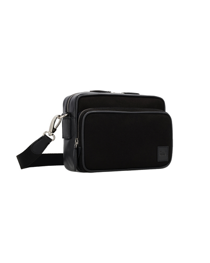 Studio Ek Inch Metropolitan canvas leather premium sling bag in black with spacious zip compartments and premium hardware. A handcrafted crossbody bag for men designed for work, travel and everyday journeys.