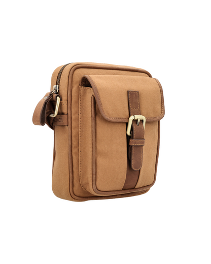 Studio Ek Inch River Sling bag in tan waterproof canvas and reclaimed leather featuring a front utility pocket, buckle closure and adjustable strap. Designed as a minimalist travel crossbody bag for men, it offers organized space for a mobile phone, wallet and everyday essentials.