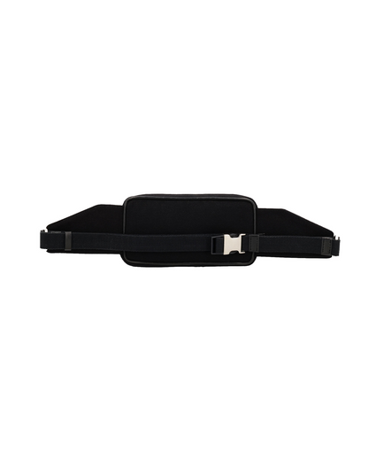 Back view of the Studio Ek Inch Urban Traveller crossbody bag in black canvas and reclaimed leather, featuring an adjustable shoulder strap and secure buckle closure. Designed as a minimalist travel bag and leather crossbody sling bag for men, it offers comfort and practicality for everyday movement and modern travel.