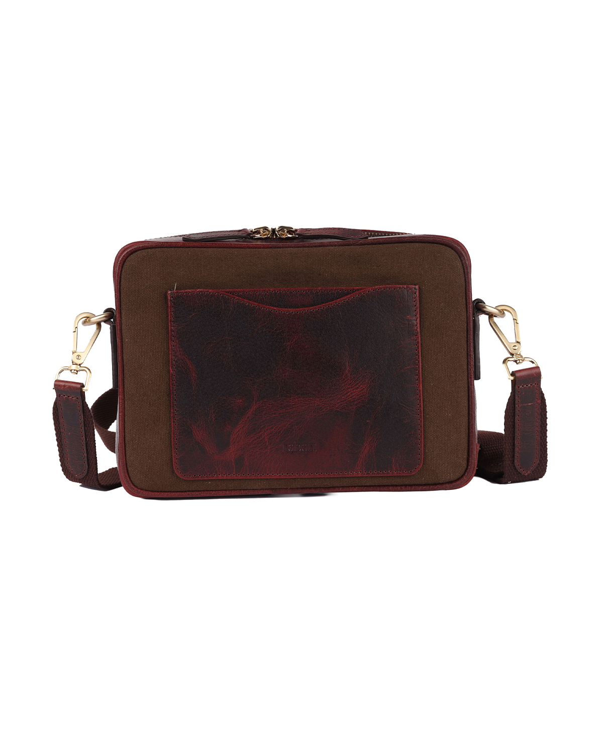Back view of the Studio Ek Inch Metropolitan Sling bag in brown waterproof canvas and reclaimed leather, featuring a rear slip pocket for quick access to a phone, passport or everyday essentials. Designed as a premium crossbody bag for travel and daily use with functional storage and timeless craftsmanship.